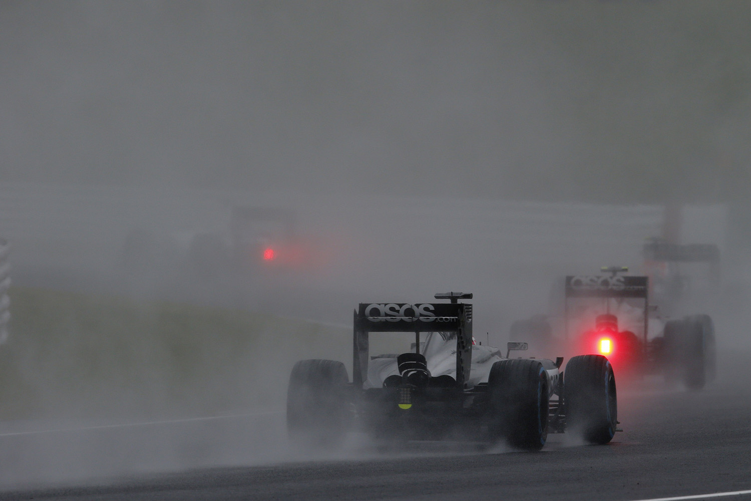 Kevin Magnussen and Jenson Button on track.